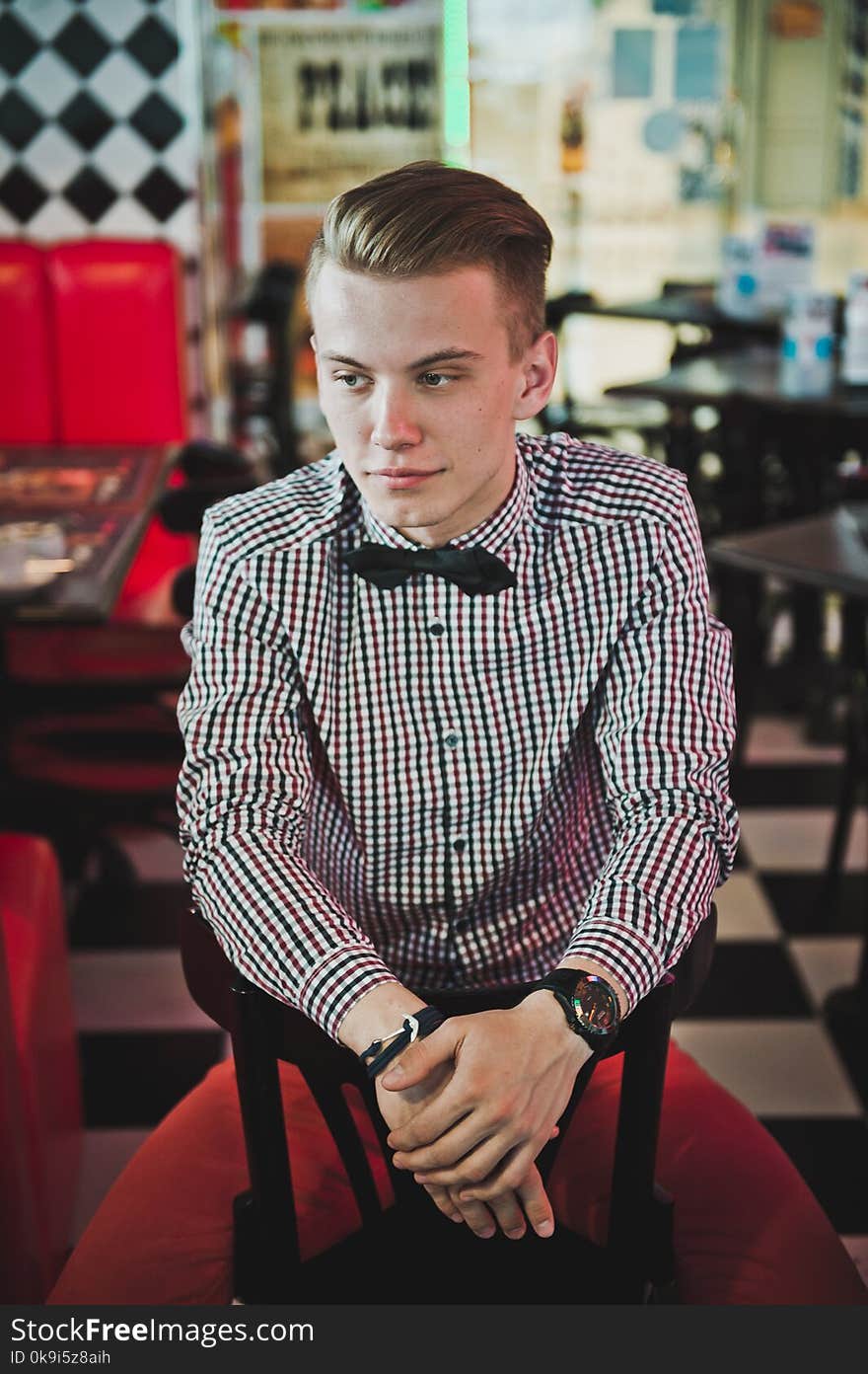 Portrait of a boy in a striped shirt and a bow tie in the cafe 5883.