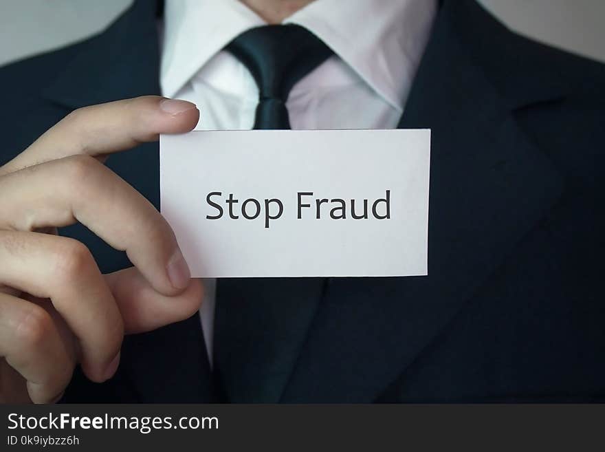 Man holding Stop fraud word on business card. Man holding Stop fraud word on business card.