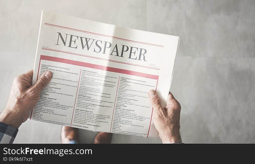 Man reading newspaper high angle view