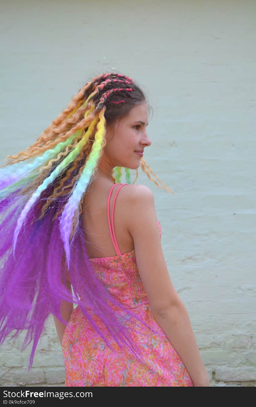 A girl with a long hair painted in rainbow colors Braids with kanekalona. Colored artificial strands of hair. Material for plaiting braids. Mastery of weaving from hair with long length of hair Tunic hair kanekalon. A girl with a long hair painted in rainbow colors Braids with kanekalona. Colored artificial strands of hair. Material for plaiting braids. Mastery of weaving from hair with long length of hair Tunic hair kanekalon