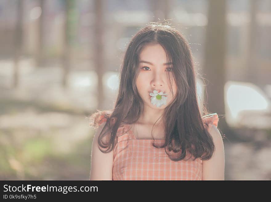 Photo of Woman with Flower on her Mouth