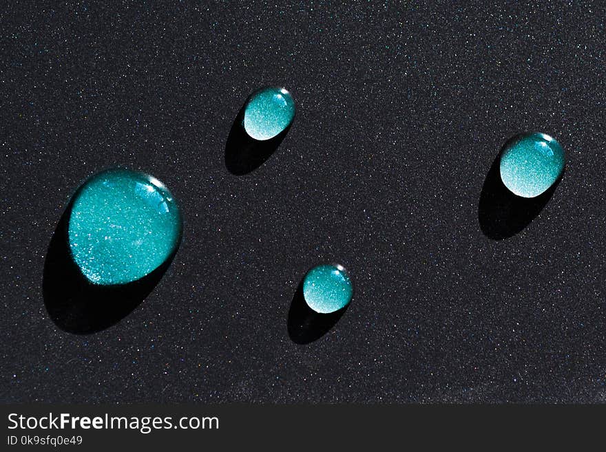 Four Water Droplets on Black Surface