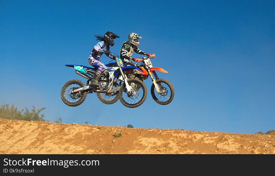 Two Person Riding Motocross Dirt Bikes