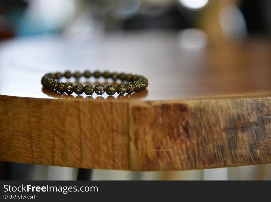 Beaded Gray Bracelet on Brown Wooden Table