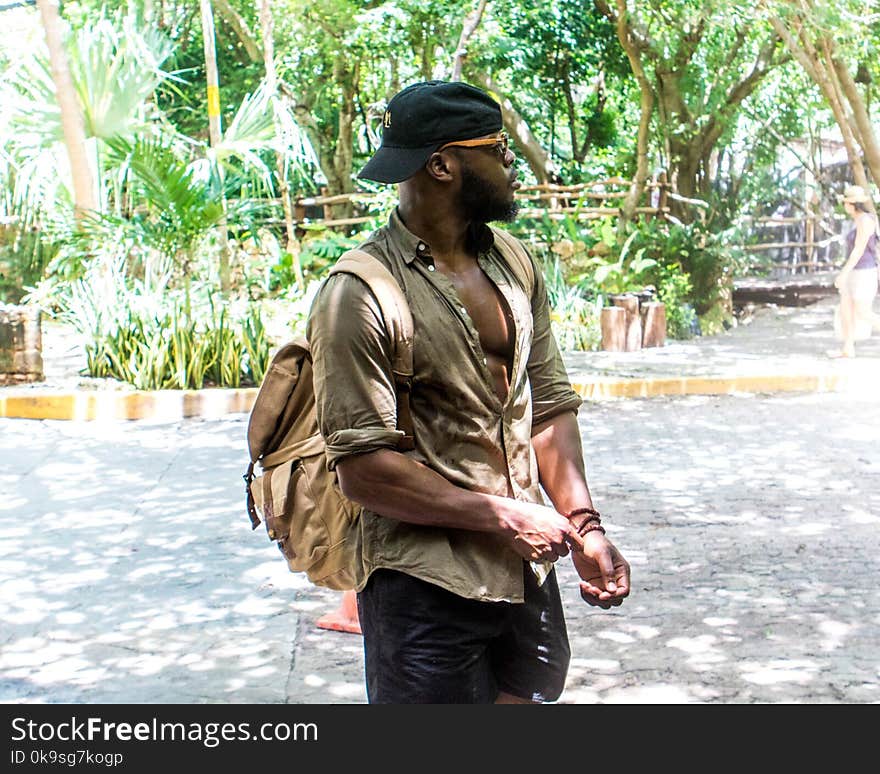 Man Wearing Hat And Backpack