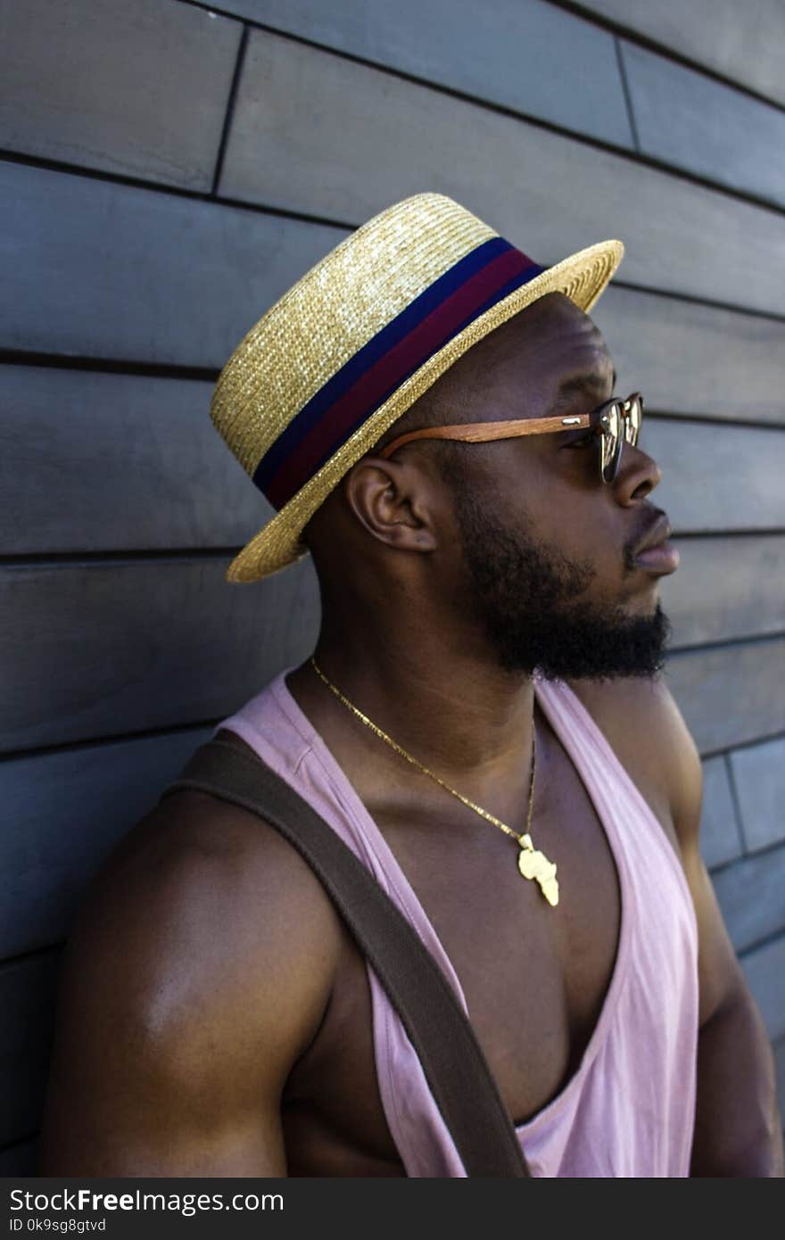 Man Wearing Hat and Pink Tank Top