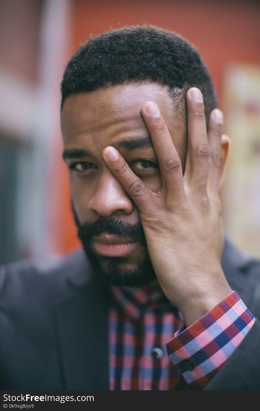 Selective Focus Photography of Man Holding His Face