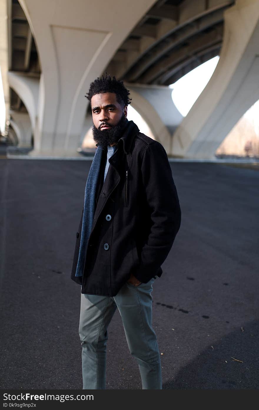 Man in Black Double-breasted Jacket in Shallow Photography