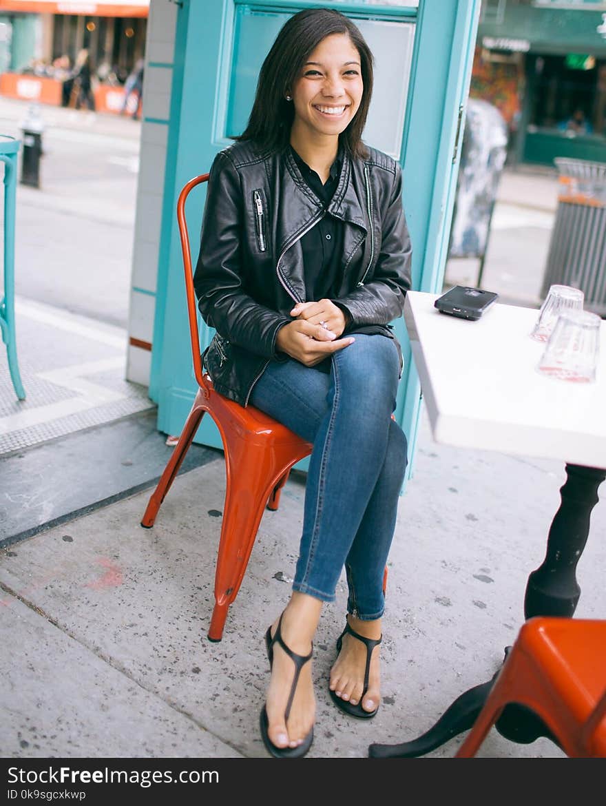 Woman Wearing Black Leather Zip-up Jacket and Blue Jeans