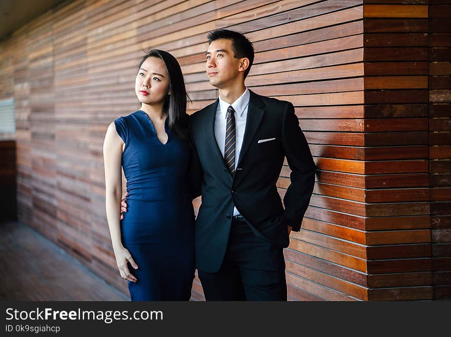 Models posing. an and Woman Standing Next to Each Other Looking Upward