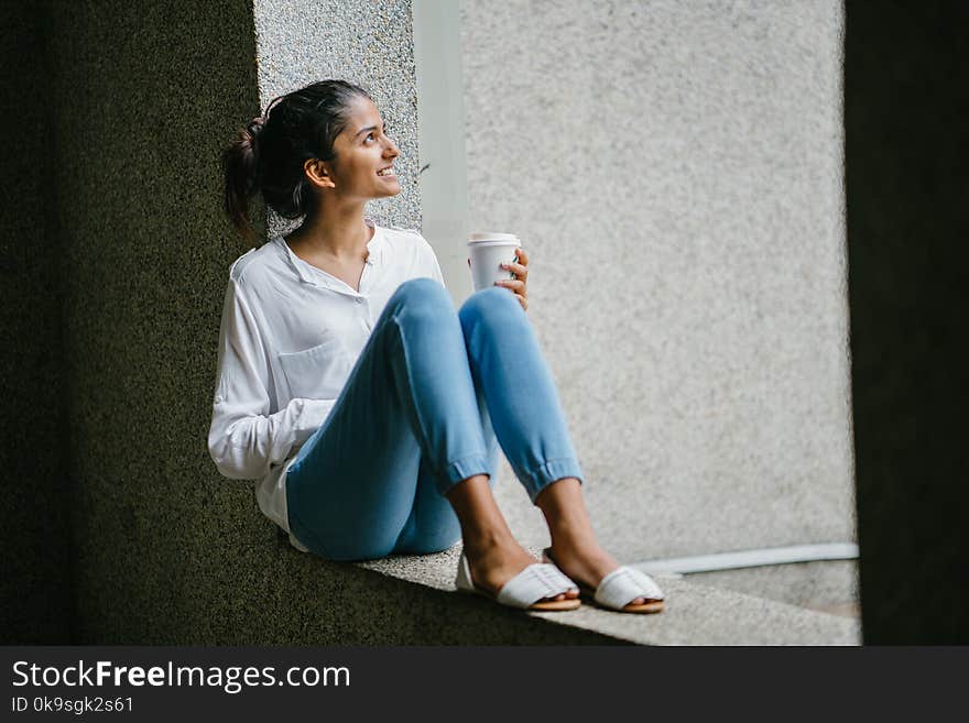 Woman posing. Wearing White Dress Shirt Sitting on Window