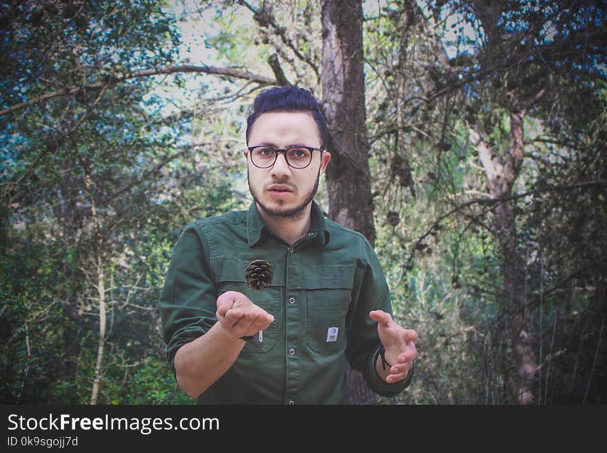 Man Wearing Green Dress Shirt and Surrounded by Trees