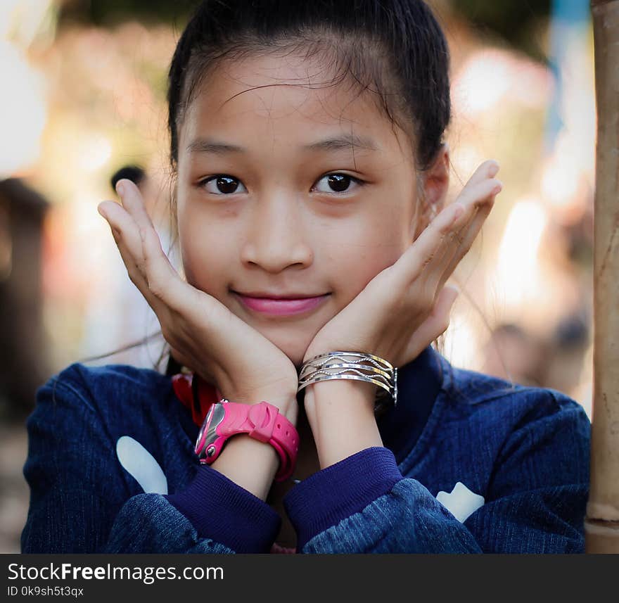 Girl Wearing Blue Long-sleeved Top Resting Face On Hands