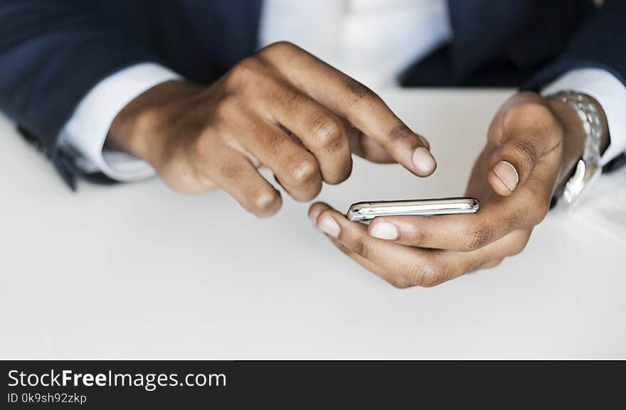 Man in Black Suit Holding Smartphone