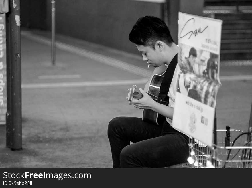 Man Playing Acoustic Guitar Grayscale Photography