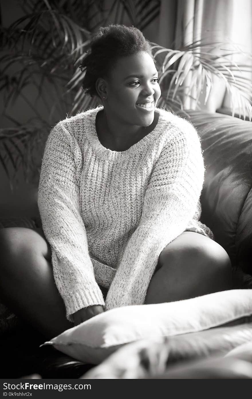 Woman Wearing Sweater Sitting On The Sofa