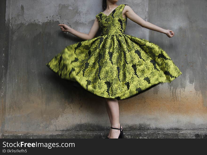 Photo of a Woman Wearing Green Dress