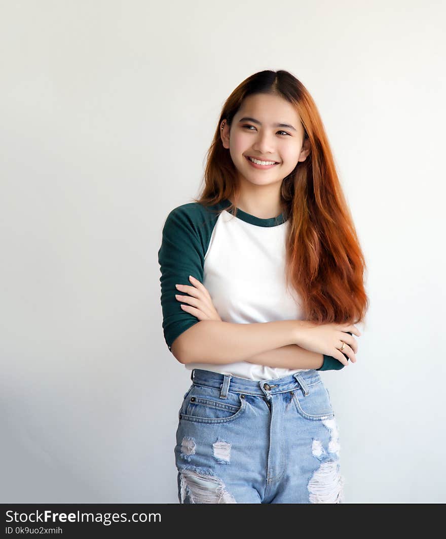 Pretty asian femele smiling joyfully with colorful hair in dress