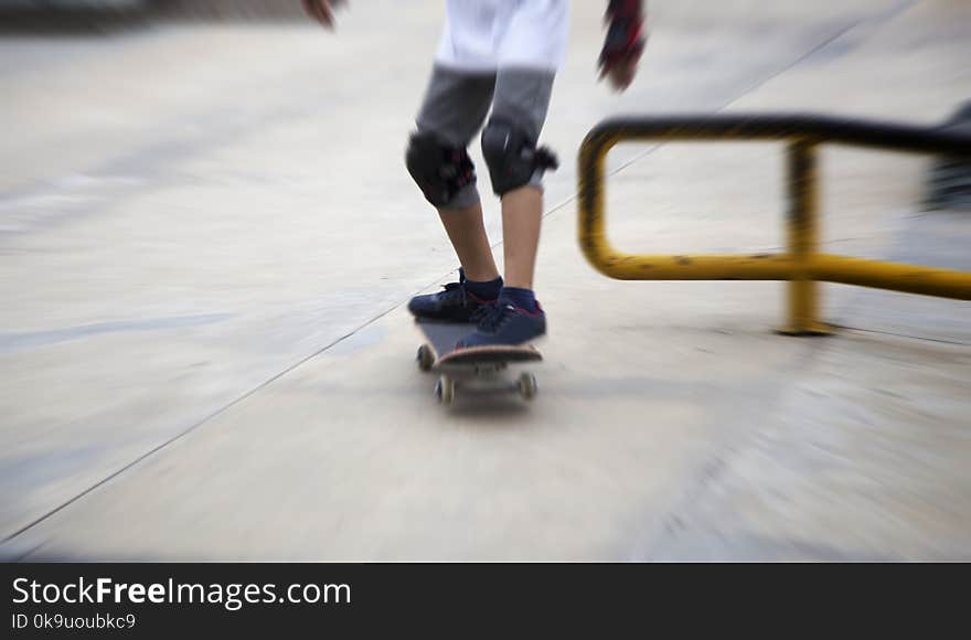 Zoom moving shot of sketeboard with child leg for practice on park. Zoom moving shot of sketeboard with child leg for practice on park