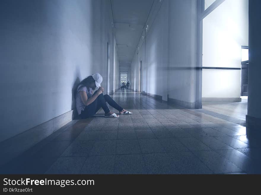 Lonely woman sitting in the hallway