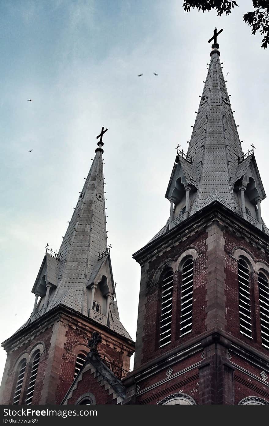 Pointed Roof Building Under Cloudy Skies