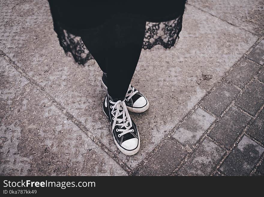 Person&#x27;s Feet Wearing Black-and-white High-top Sneakers