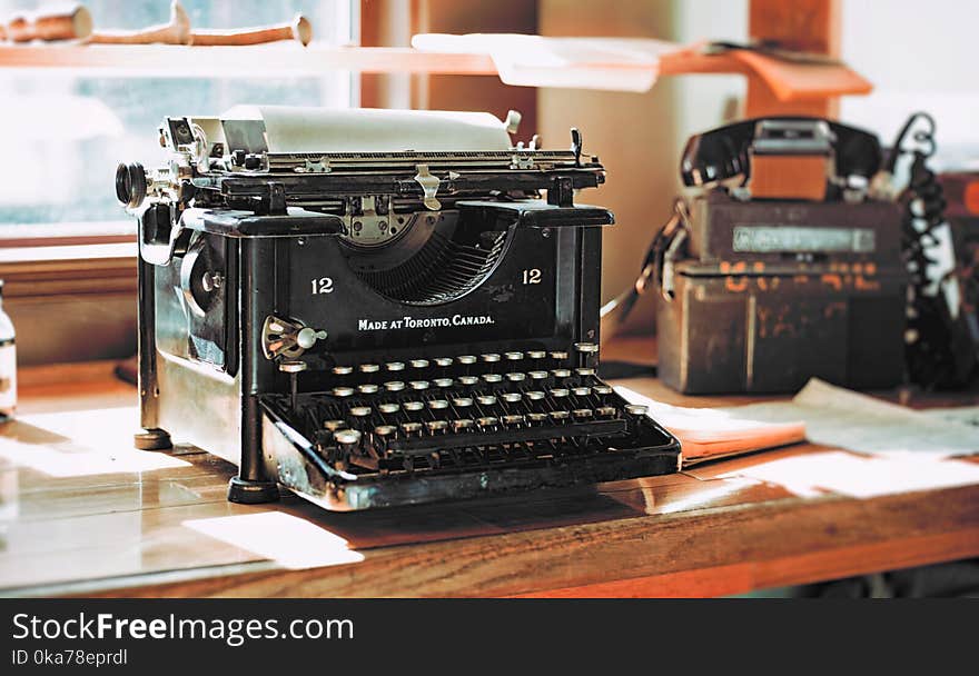 Classic Black Typewriter on Brown Wooden Desk