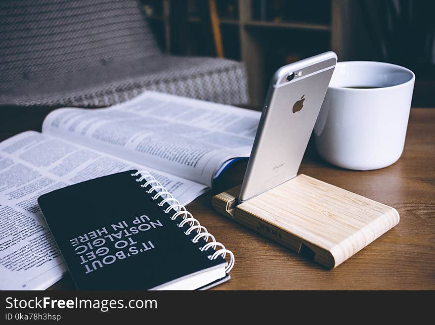 Book and Silver Iphone 6 on Top of Table