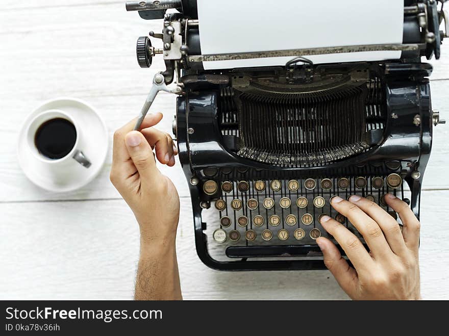 Person Typing Using Typewriter