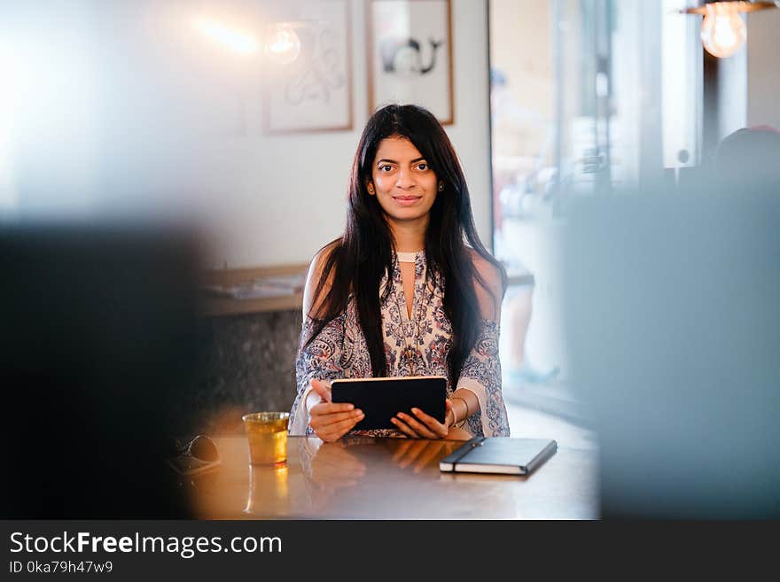 Woman Holding Black Tablet