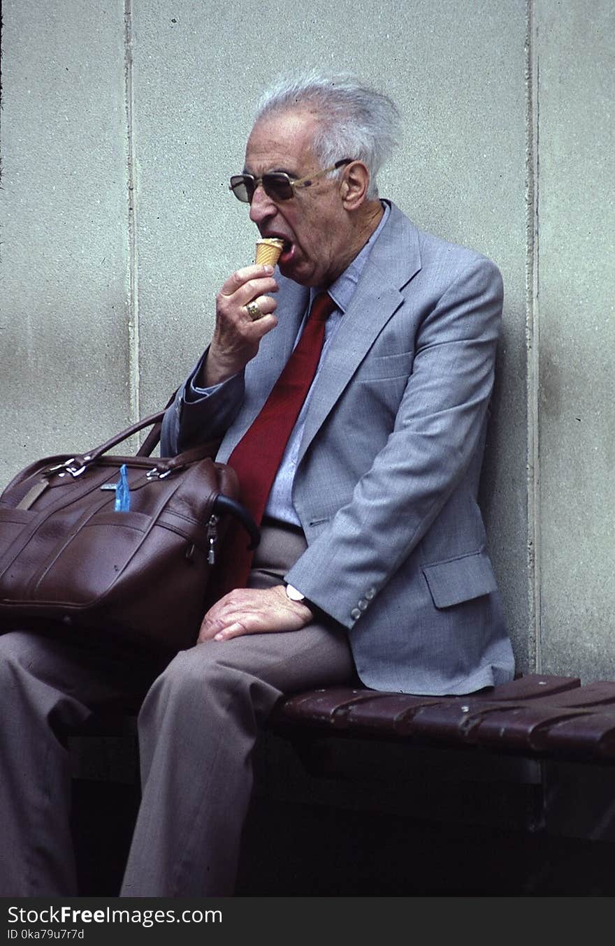 Man In Grey Suit Eating Ice Cream