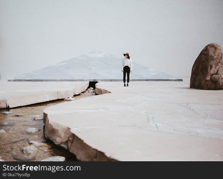 Woman Standing Near Big Rock