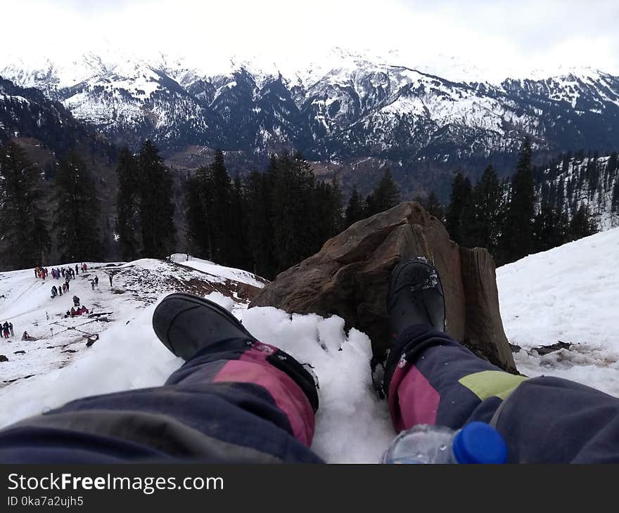 Person Wearing Black Boots At Snowy Mountain