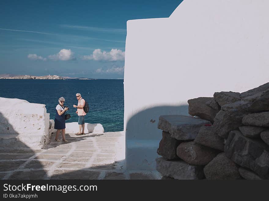 Two People Next To Ocean