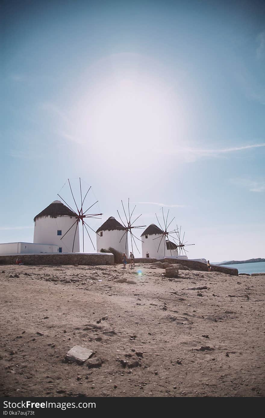 Four Windmills Near Body Of Water