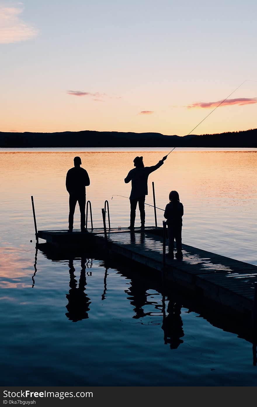 Three People on a Wooden Fishing Docks