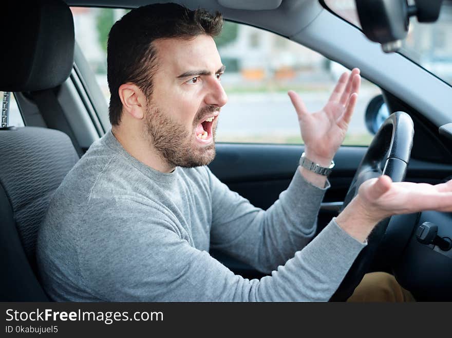 Angry and rude driver portrait sitting in his car. Angry and rude driver portrait sitting in his car