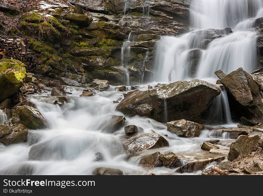 Mountain waterfall with rocky stones, nature background suitable for wallpaper