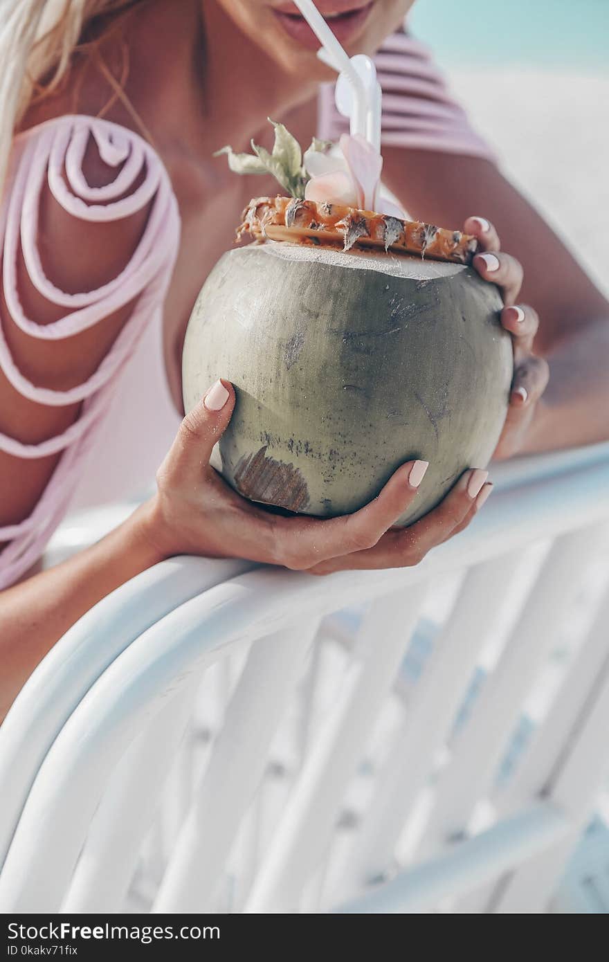 Travel series. girl holding coconut cocktail. Travel series. girl holding coconut cocktail