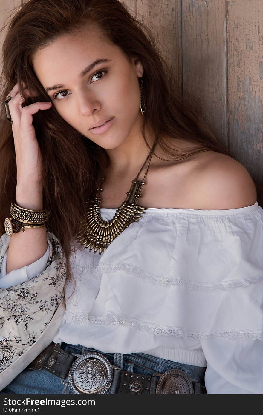 Photo of a Woman Wearing White Off-shoulder Top