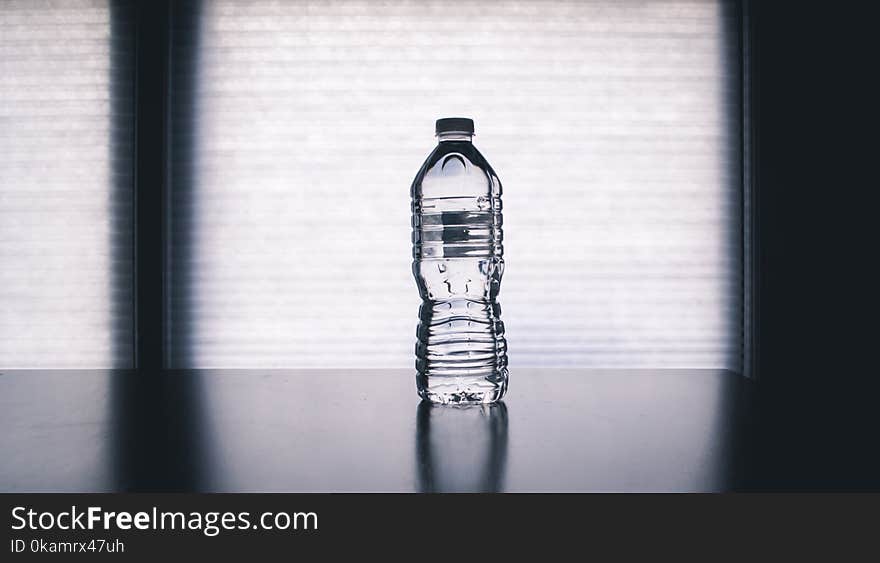 Clear Disposable Bottle on Black Surface