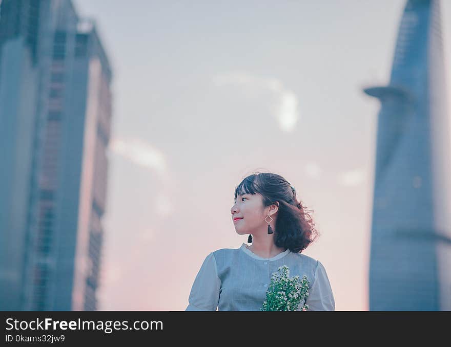 Photo of Woman Wearing Gray Button-up Top