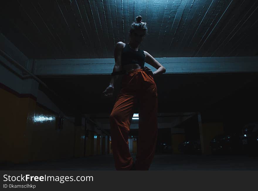 Woman Wearing Black Crop Top With Orange Pants