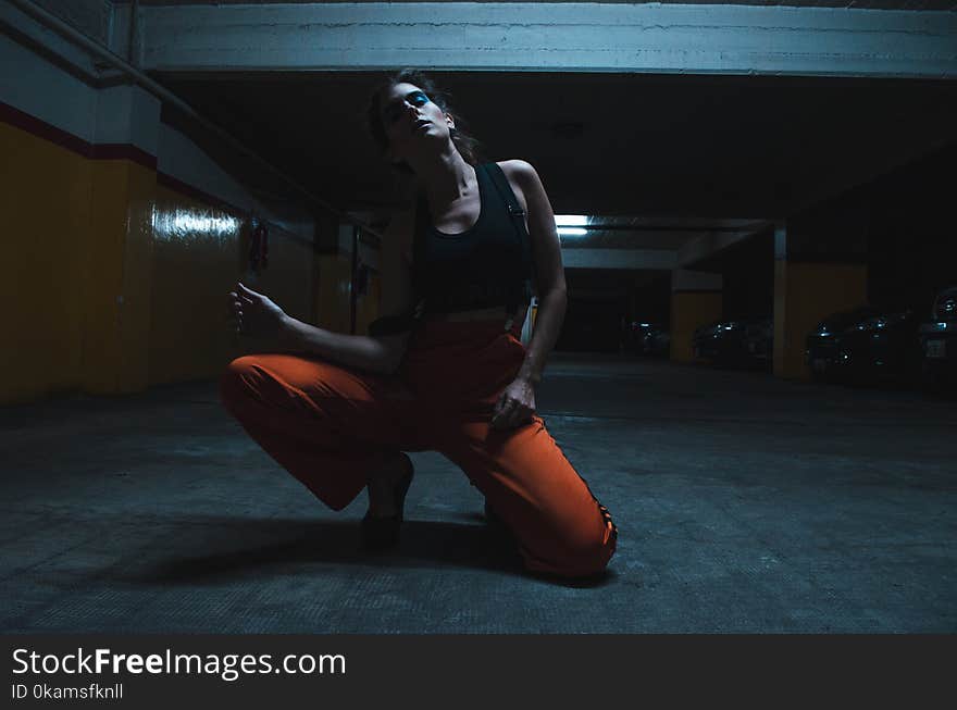 Woman Wearing Tank Top and Kneeling on the Floor