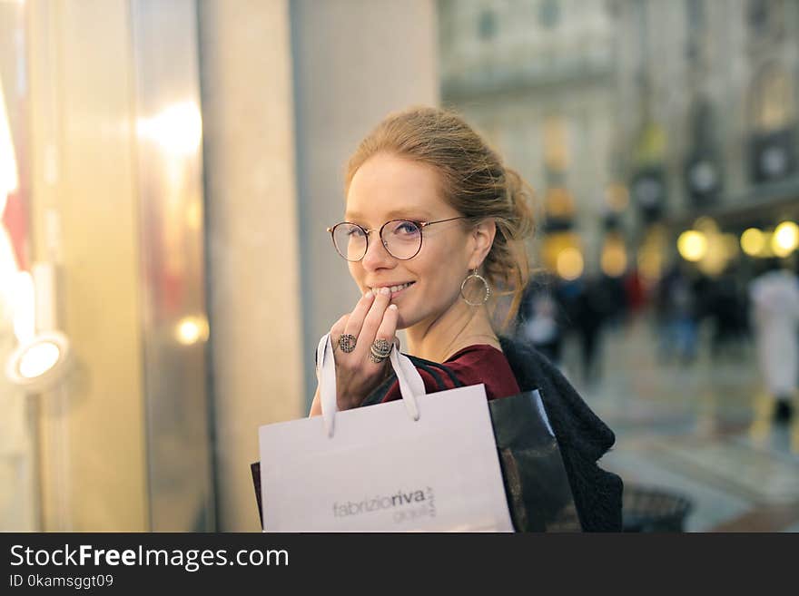 Close-Up Photography of a Woman Holding Paper Bags