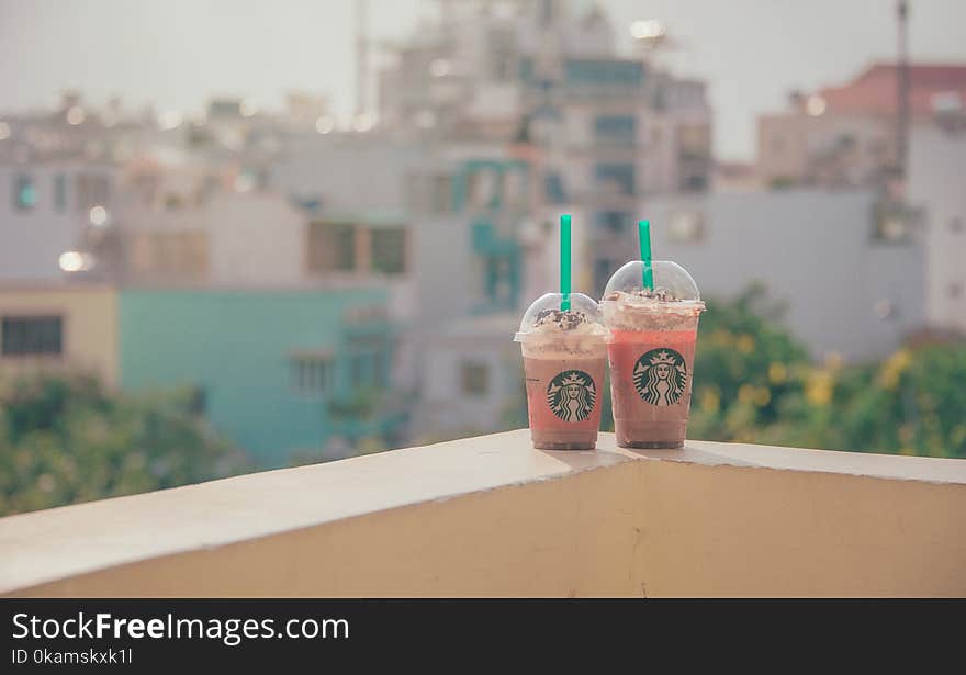 Close-Up Photography of Two Starbucks Disposable Cups