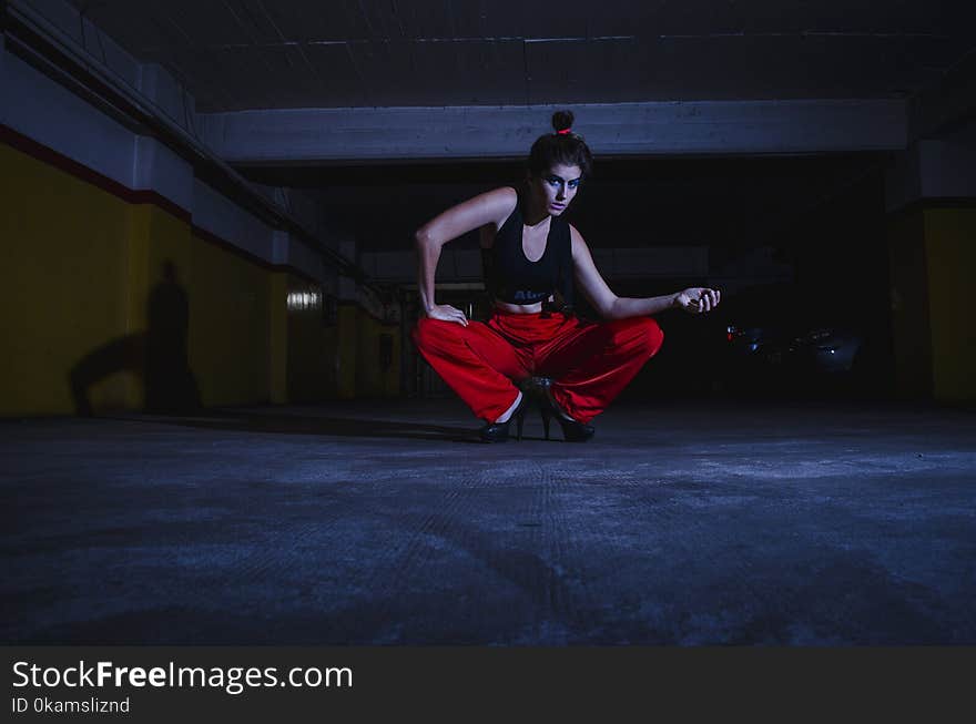 Photo of Woman Wearing Sports Bra and Red Pants