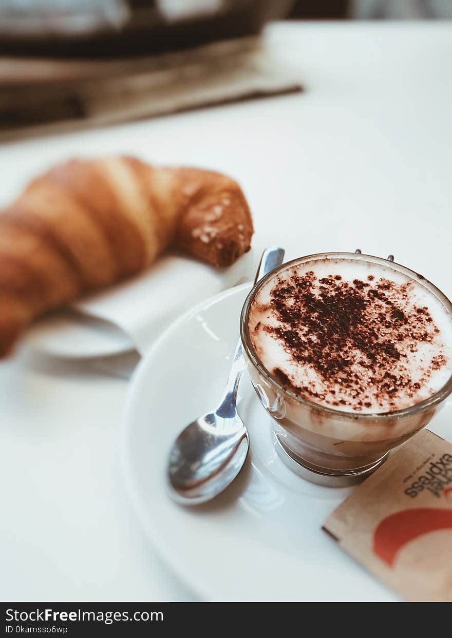 Selective Focus Photo of a Cup Filled With Coffee on White Ceramic Saucer