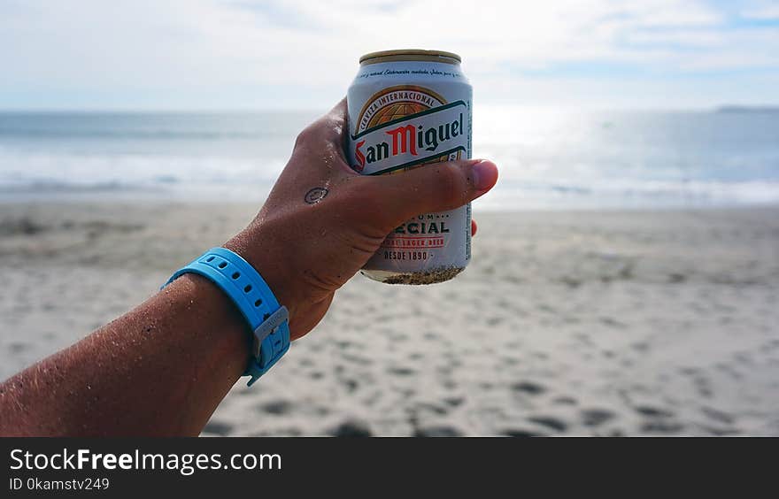 Person Holding San Miguel Beer Tin Can