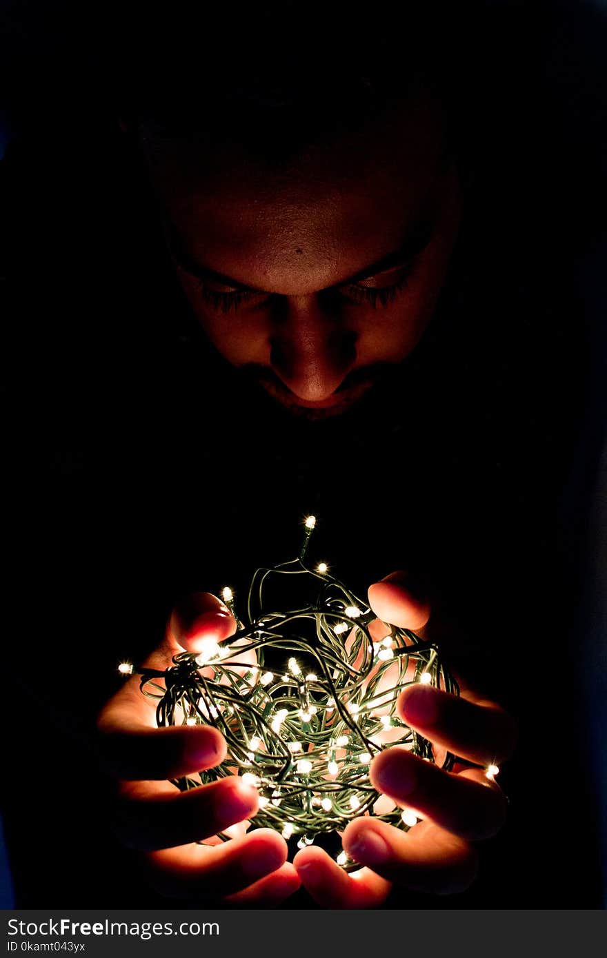 Man Holding String Light